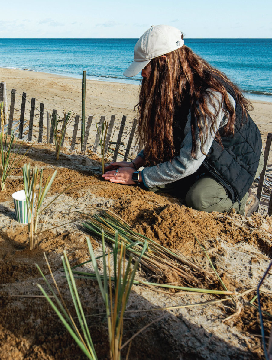 woman planting near the ocean