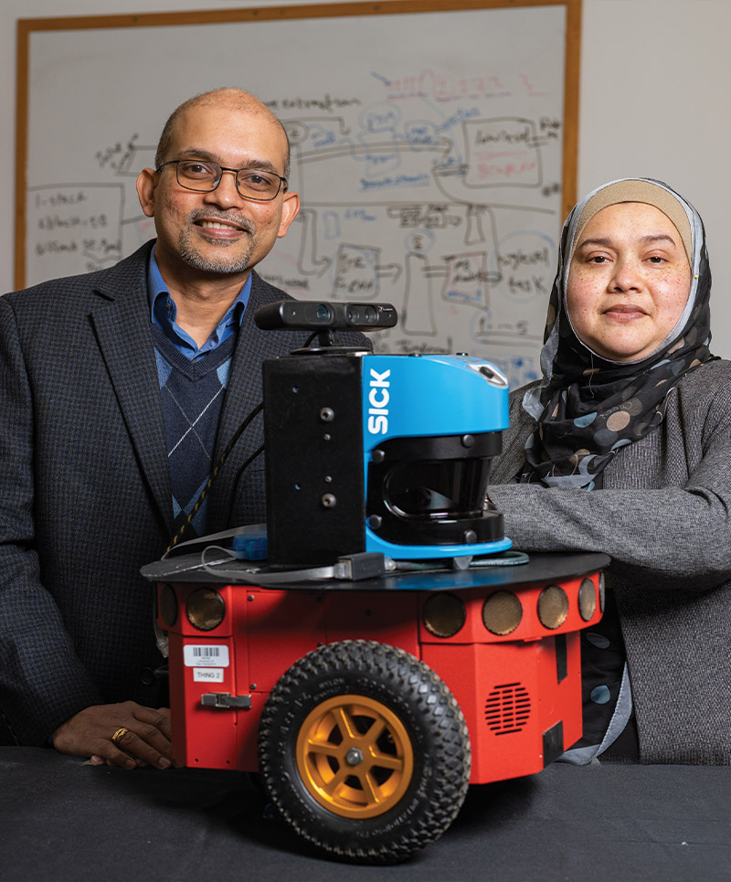 CoRE collaborators Sajay Arthant and Momotaz Begum with their assistive robot